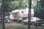 rv lot in the woods with fifth wheel